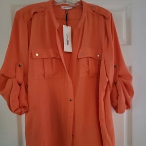New Calvin Klein short sleeve button  down blouse, even hem all around.